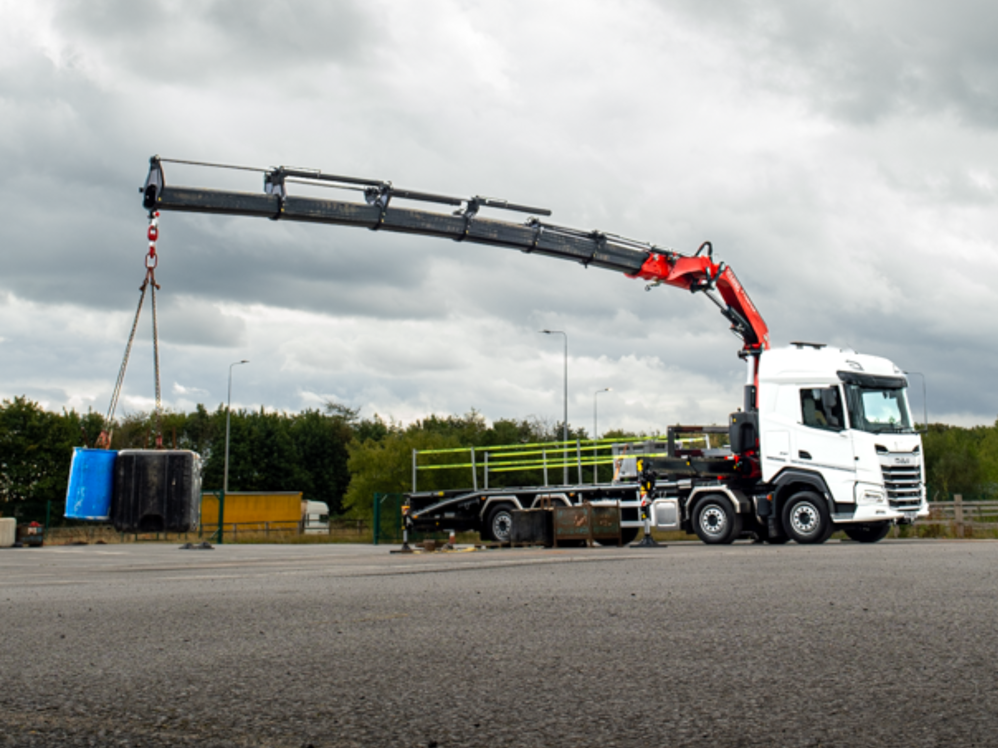 A crane and hiab truck lifting materials, ready to rent or hire